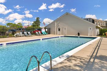 Outdoor swimming pool with lounge chairs and cabana
